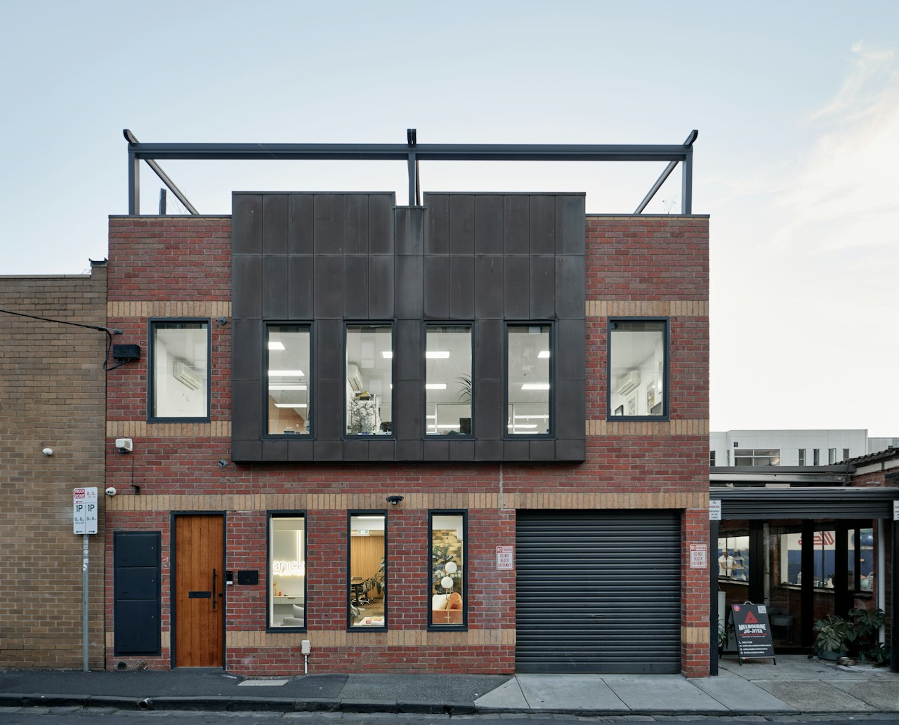 Modern home extension with dark cladding and integrated garage