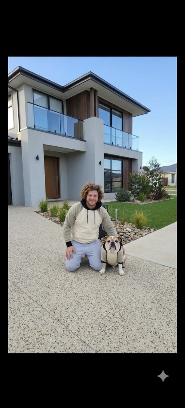 Nathan and his bulldog Mac out the front of a finished Born to Build home